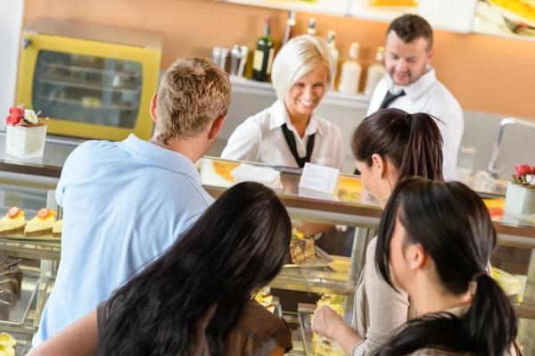 Buying cakes at cafeteria queue desserts