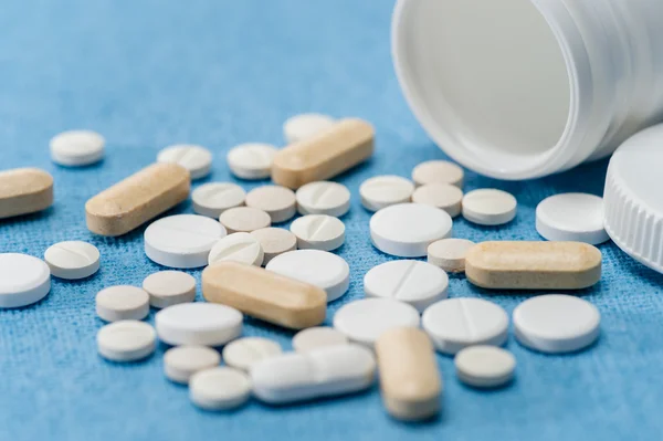 Medicament pills on medical blue background