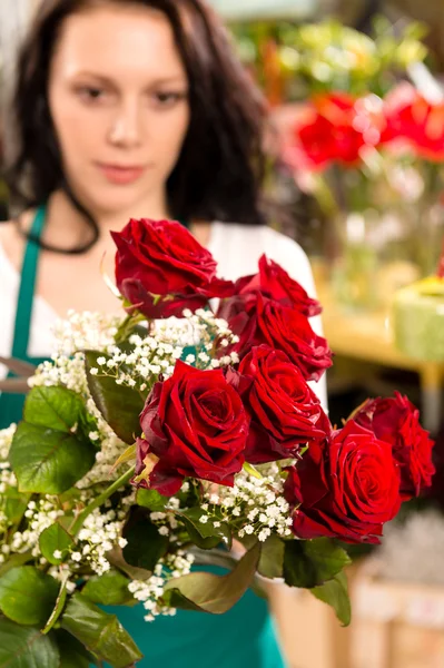 Young woman making flower bouquet florist shop