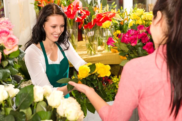 Cheerful flower shop florist customer buying yellow