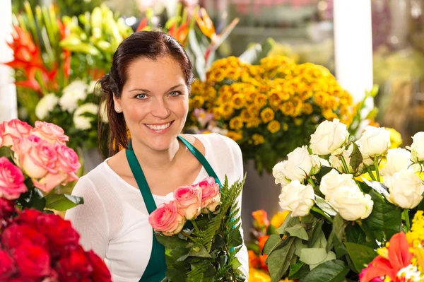 Smiling florist flower shop colorful making bouquet