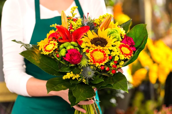 Florist holding bouquet colorful flowers shop assistant