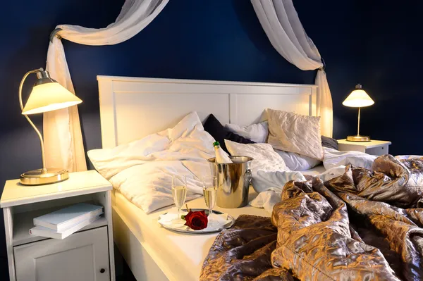 Rumpled sheets hotel bedroom romantic night