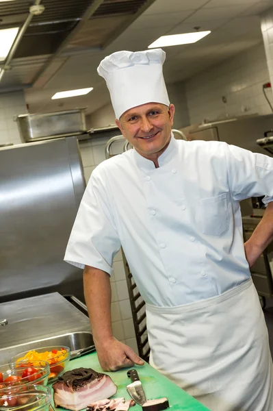 Male chef posing in commercial kitchen