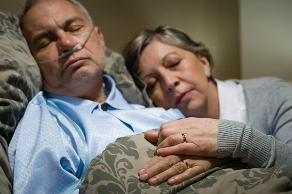 Old couple sleeping together man nasal cannula