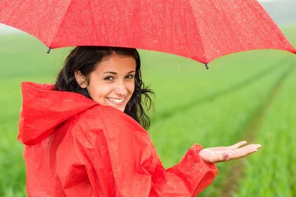 Lively teenager girl in the rain