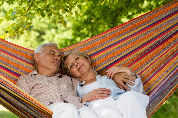 Senior couple relax sleeping in hammock