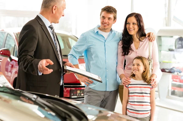 Salesman offering a car to family