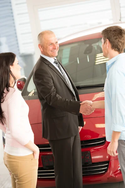 Couple buying a car in dealership