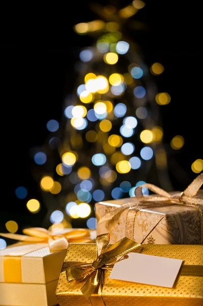 Christmas tree and wrapped presents with label