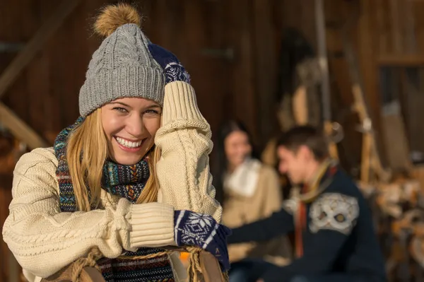 Young smiling woman in winter clothes cottage