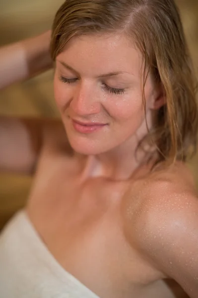 Woman sweating in the sauna