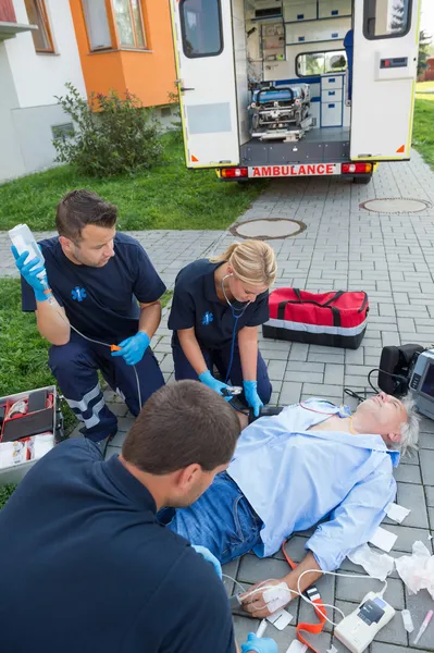 Paramedics treating injured man