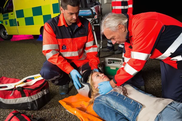 Paramedics removing helmet from driver