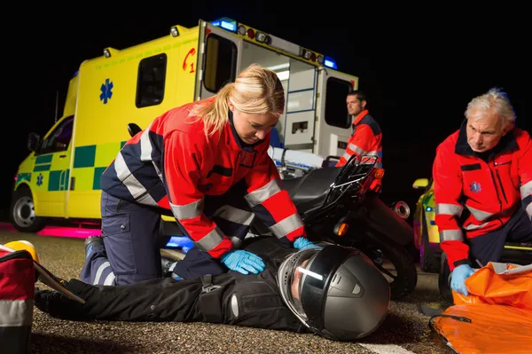 Paramedical team assisting injured driver