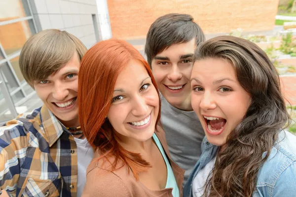 Cheerful student friends taking selfie