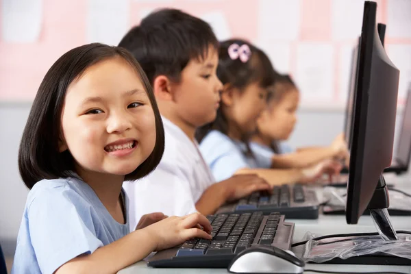 Female Pupil Using Keyboard During Computer Class In Chinese Sch