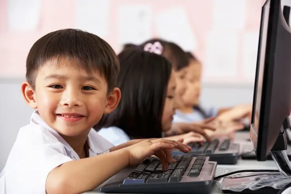 Male Pupil Using Keyboard During Computer Class In Chinese Schoo