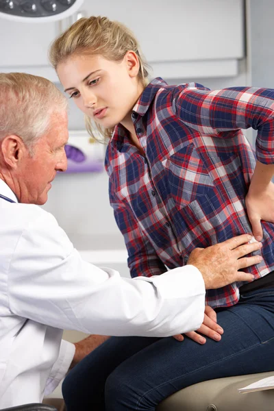 Teenage Girl Visits Doctor's Office With Back Pain