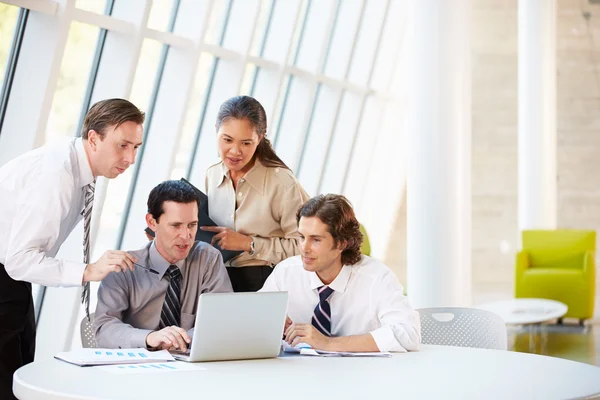 Businesspeople Having Meeting Around Table In Modern Office