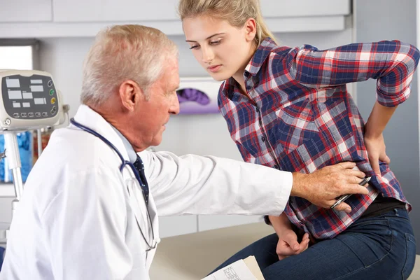 Teenage Girl Visits Doctor\'s Office With Back Pain