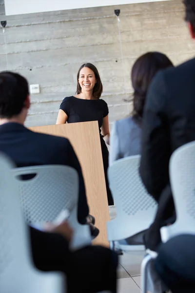 Businesswoman Delivering Presentation At Conference