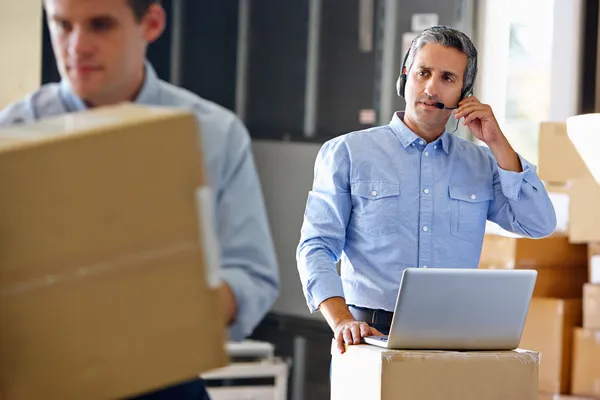 Manager Using Headset In Distribution Warehouse