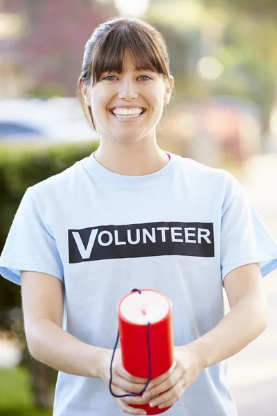 Portrait Of Charity Volunteer On Street With Collection Tin