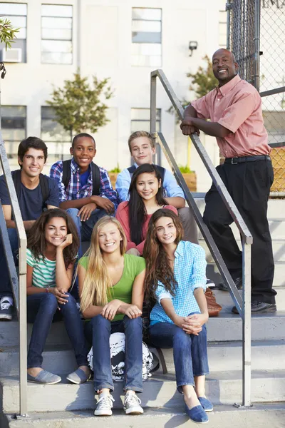 Group Of Teenage Pupils Outside Classroom With Teacher