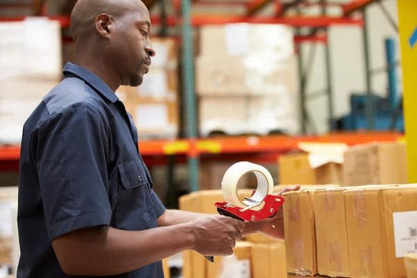 Workers In Warehouse Preparing Goods For Dispatch