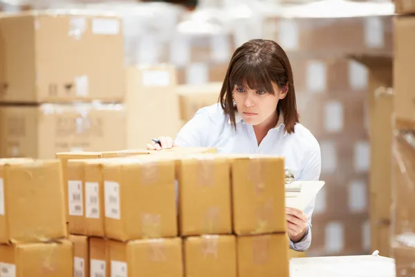 Worker In Warehouse Preparing Goods For Dispatch