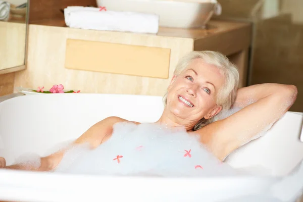 Senior Woman Relaxing In Bubble Bath