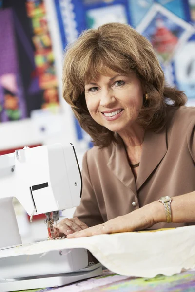 Woman Using Electric Sewing Machine