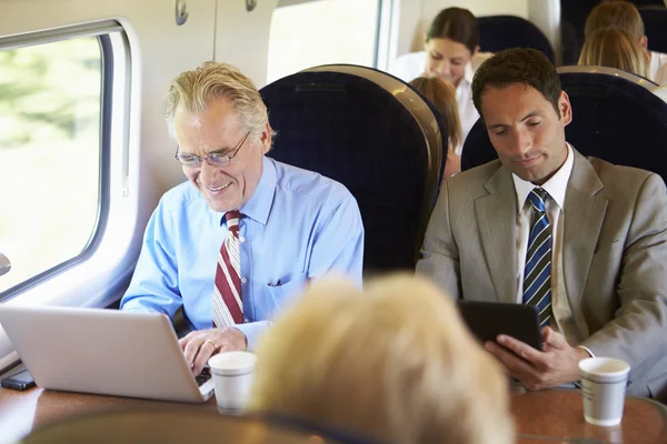 Businesspeople traveling by train