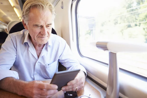 Old man using digital tablet