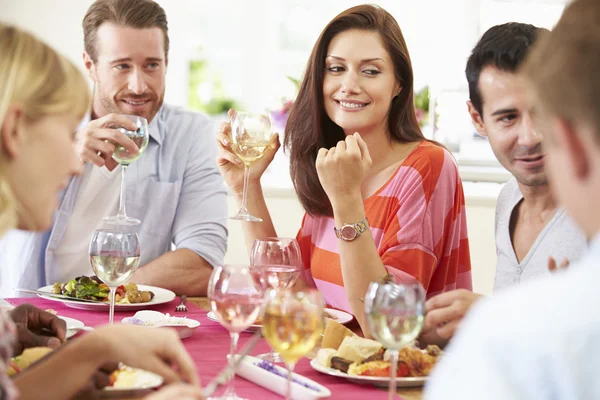 Friends Sitting Around Table Having Dinner