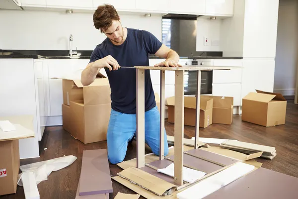 Man Putting Together Assembly Furniture