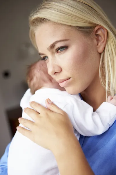 Depressed Mother Cuddling Baby