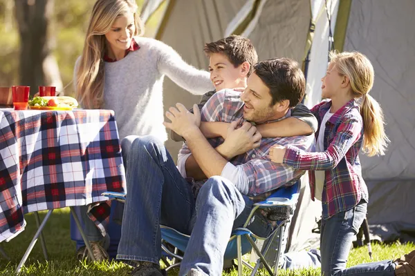 Family Enjoying Camping Holiday In Countryside