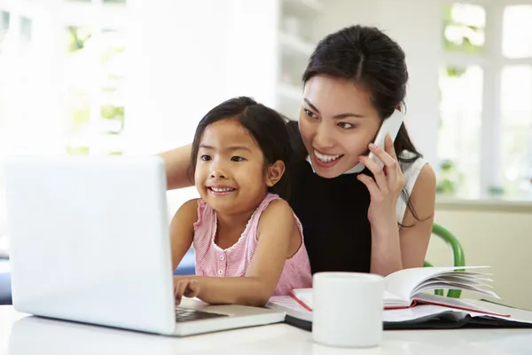 Busy Mother Working From Home