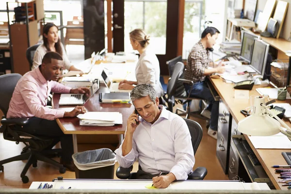 Interior Of Busy Architect's Office With Staff Working