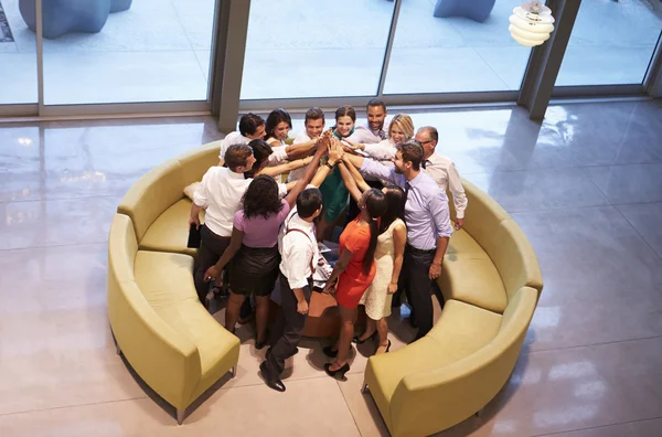 Businesspeople Giving Each Other High Five In Office Lobby