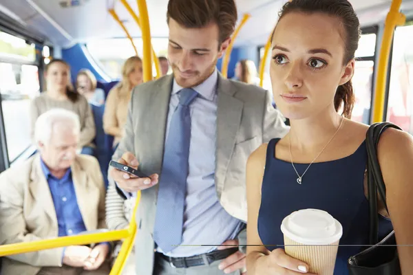 Passengers Standing On Busy Commuter Bus