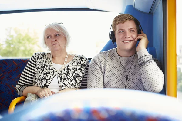Man Disturbing Passengers On Bus Journey With Loud Music