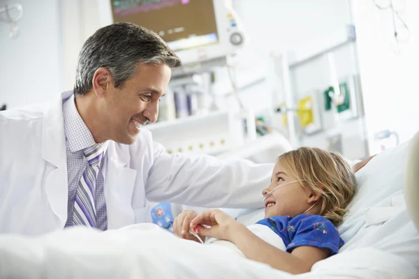 Young Girl Talking To Male Doctor In Intensive Care Unit