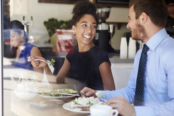 Two Businesspeople Meeting For Lunch In Coffee Shop