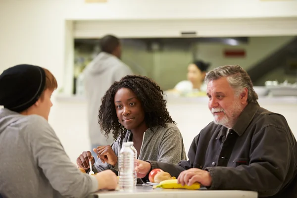 People  Eating In Homeless Shelter