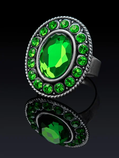 Silver ring with green (glass) stones.