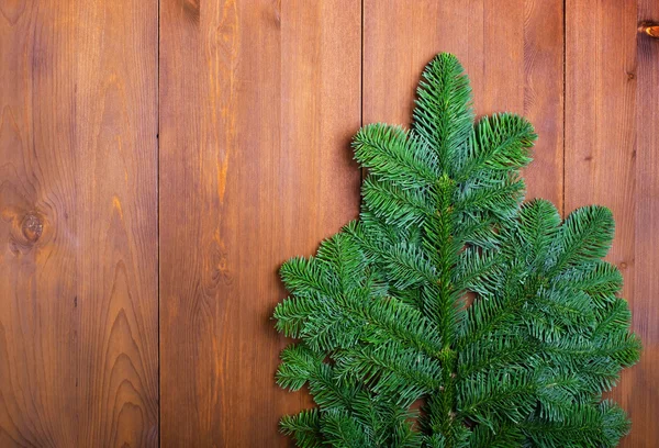 Fir branches on wooden boards