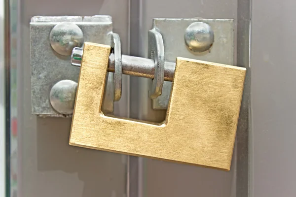 Closed padlock on a metal door